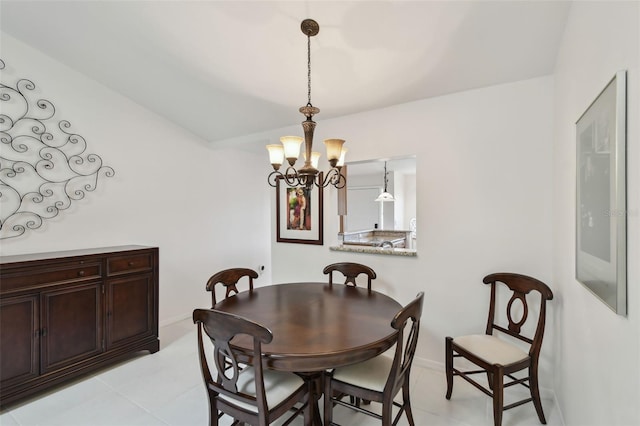 dining room featuring a chandelier and baseboards