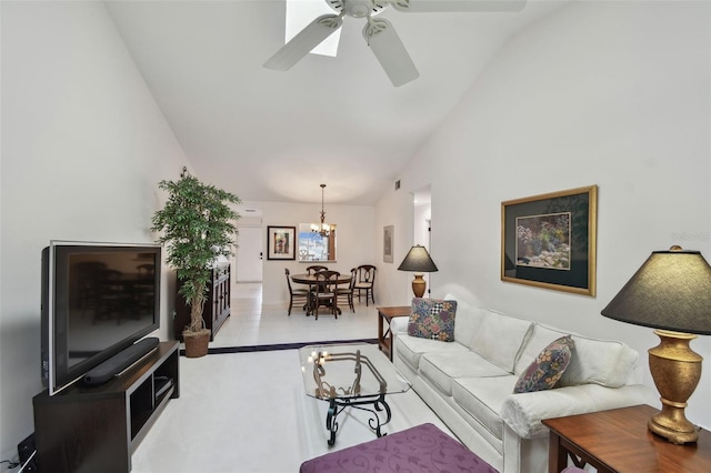 living area with vaulted ceiling and ceiling fan with notable chandelier