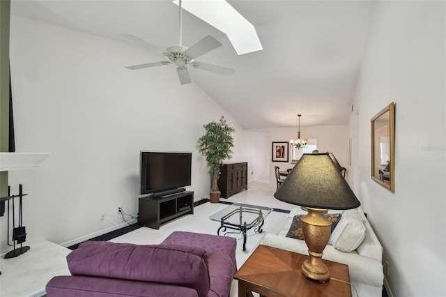 living room with baseboards, high vaulted ceiling, a skylight, and ceiling fan with notable chandelier