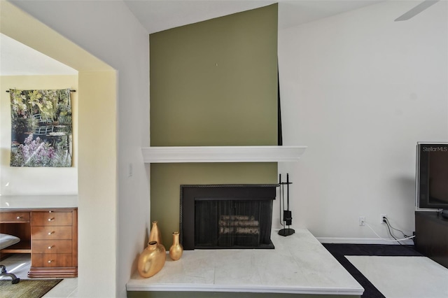 living area with a fireplace with raised hearth