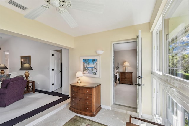 interior space with visible vents, baseboards, ceiling fan, and light tile patterned flooring