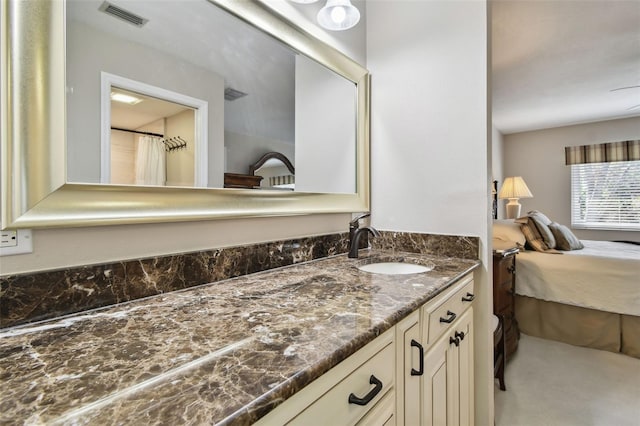 bathroom featuring visible vents, connected bathroom, and vanity