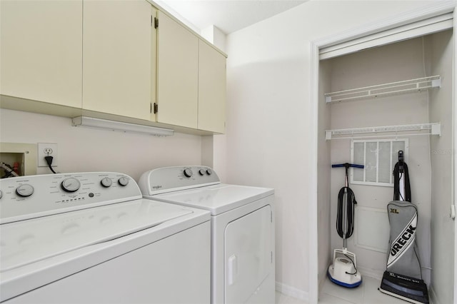 laundry room with washing machine and dryer and cabinet space