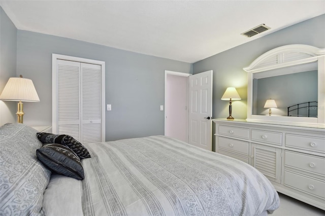 bedroom featuring visible vents and a closet