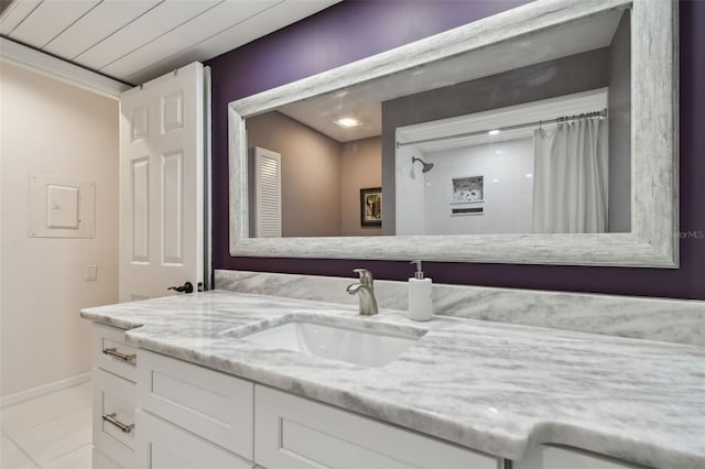 full bathroom with baseboards, a shower with curtain, vanity, and tile patterned flooring