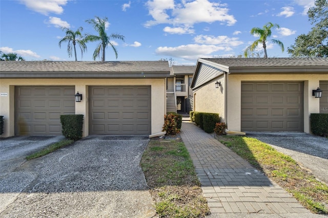 view of property with driveway and stucco siding