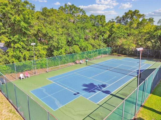 view of tennis court featuring fence