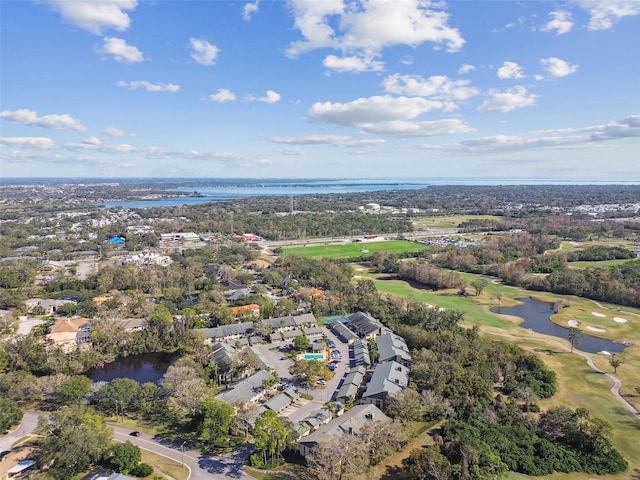 aerial view with golf course view and a water view