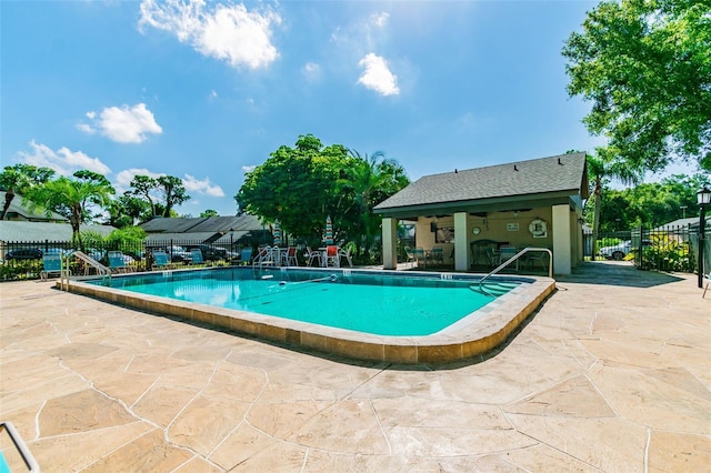 pool featuring a patio and fence