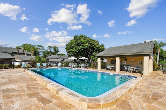 community pool featuring a patio area and fence