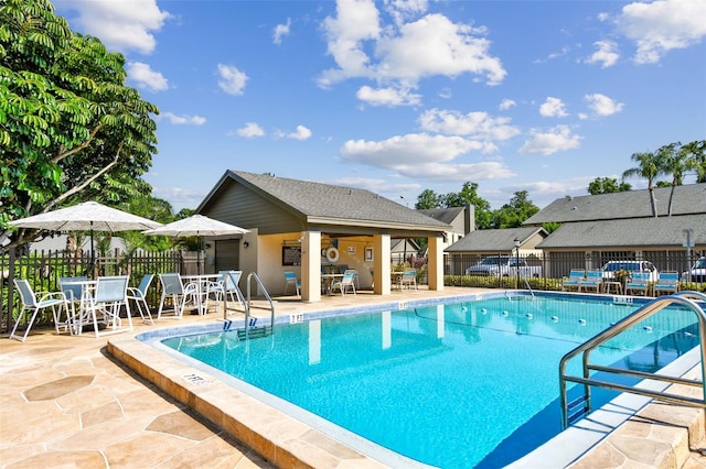 pool featuring a patio and fence