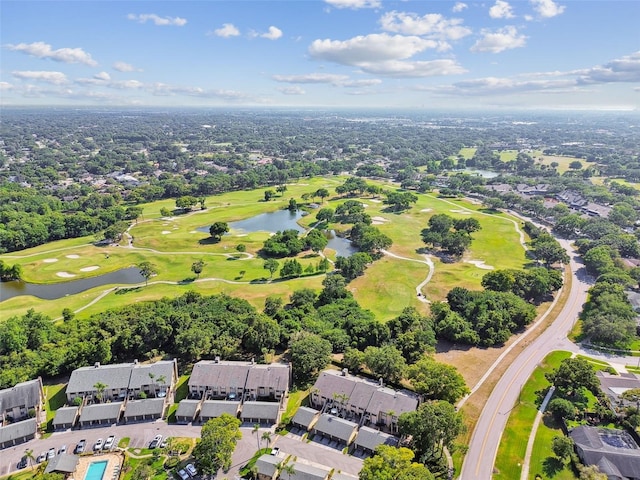 aerial view with golf course view, a water view, and a residential view