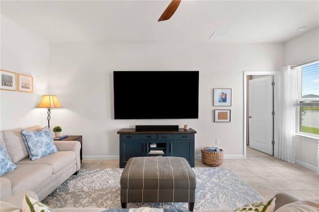 living room featuring light tile patterned floors and ceiling fan