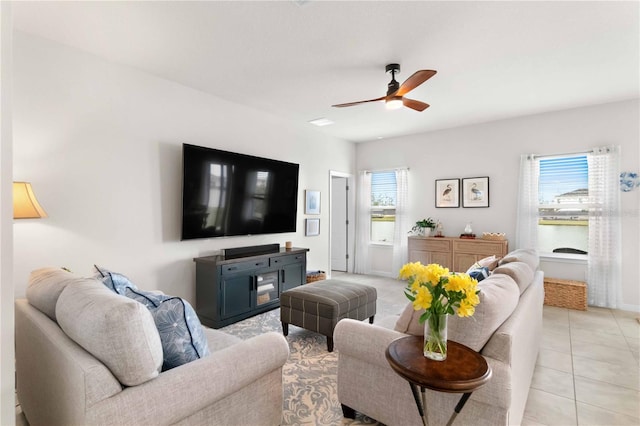 living room featuring a wealth of natural light, ceiling fan, and light tile patterned flooring