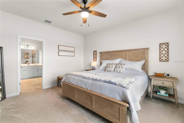 carpeted bedroom featuring ensuite bath and ceiling fan