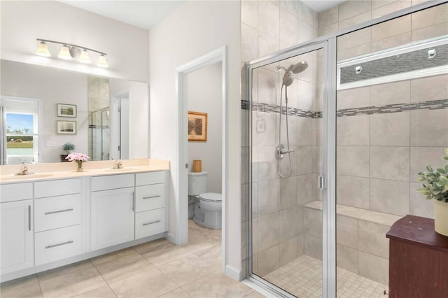 bathroom with vanity, an enclosed shower, tile patterned flooring, and toilet