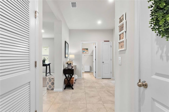 hall with light tile patterned floors