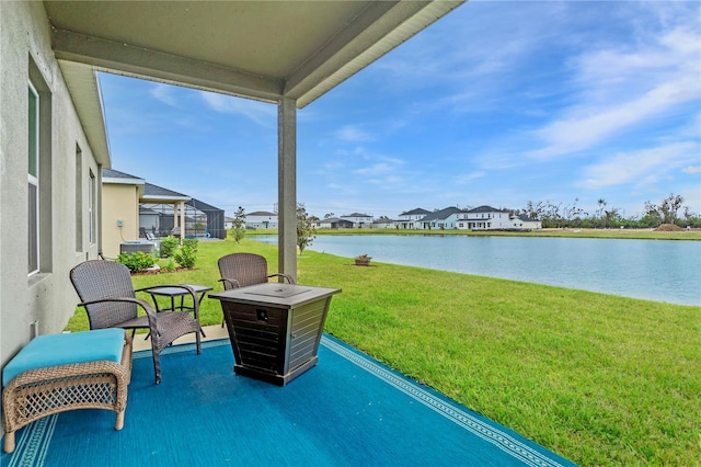 view of patio / terrace with a water view and glass enclosure