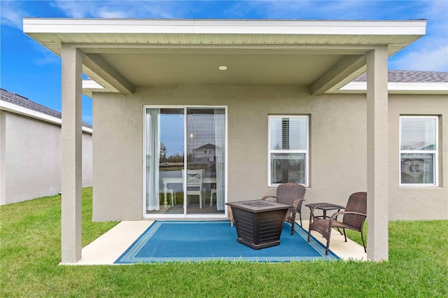 rear view of property with a yard and a patio area