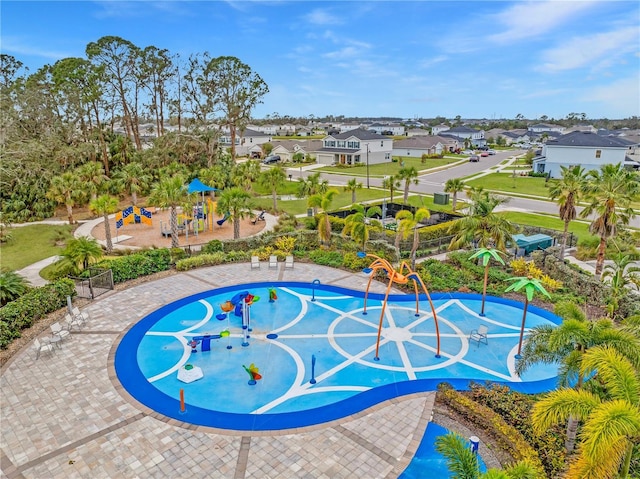 view of swimming pool with a playground