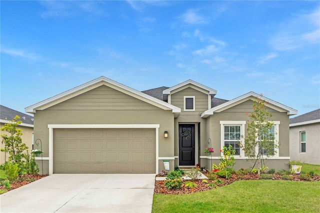 view of front of house with a garage and a front yard