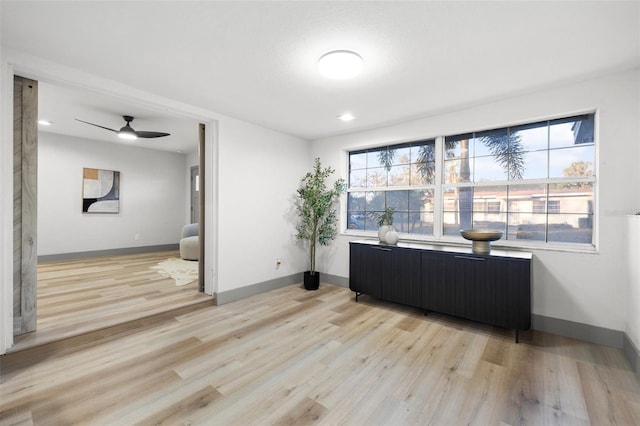 living room with ceiling fan, radiator heating unit, and light hardwood / wood-style floors