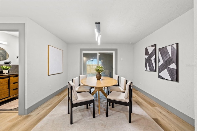 dining space with light wood-type flooring