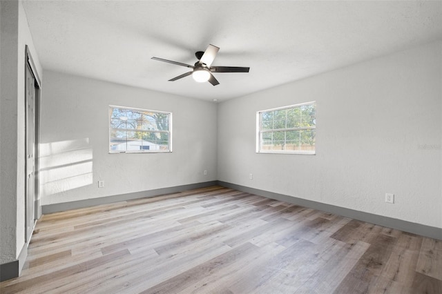 unfurnished room featuring ceiling fan and light wood-type flooring