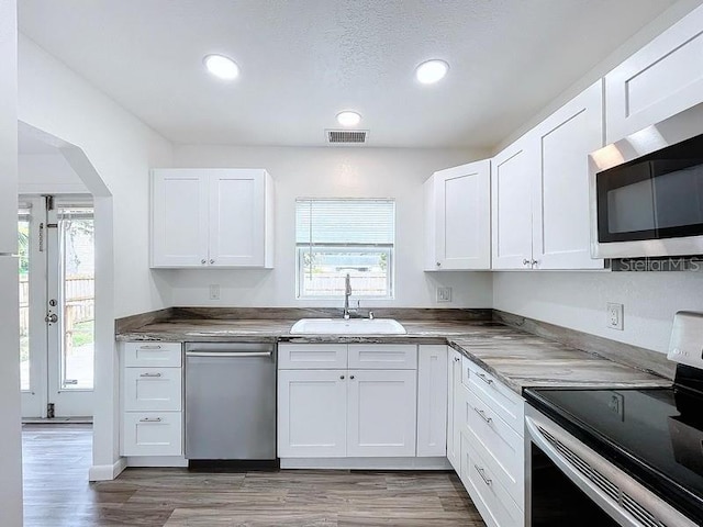 kitchen featuring appliances with stainless steel finishes and white cabinets