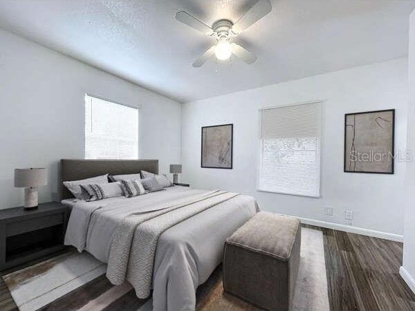 bedroom with ceiling fan and dark hardwood / wood-style flooring