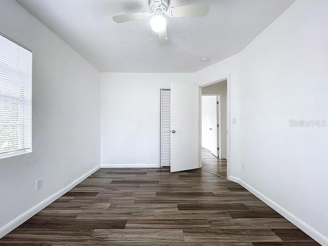 spare room with dark hardwood / wood-style floors and ceiling fan