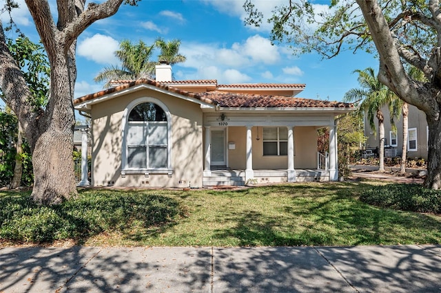 mediterranean / spanish-style house featuring a front lawn and a porch