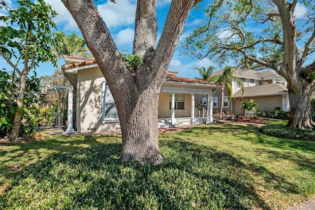 view of front of house featuring covered porch and a front lawn