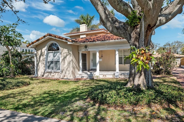 view of front of house featuring a front yard and covered porch