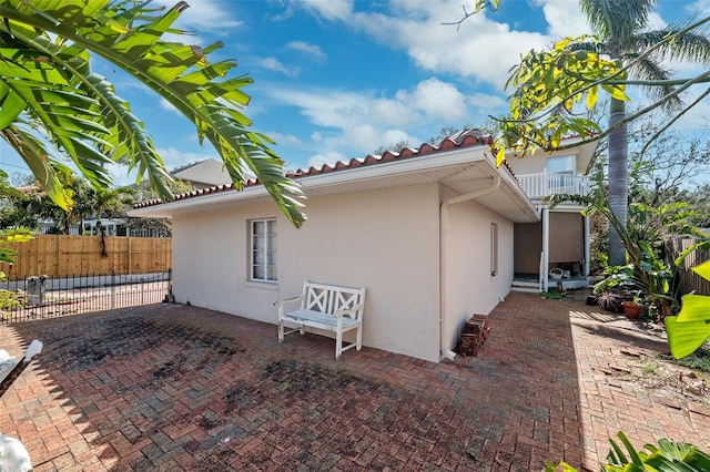 view of side of home featuring a balcony