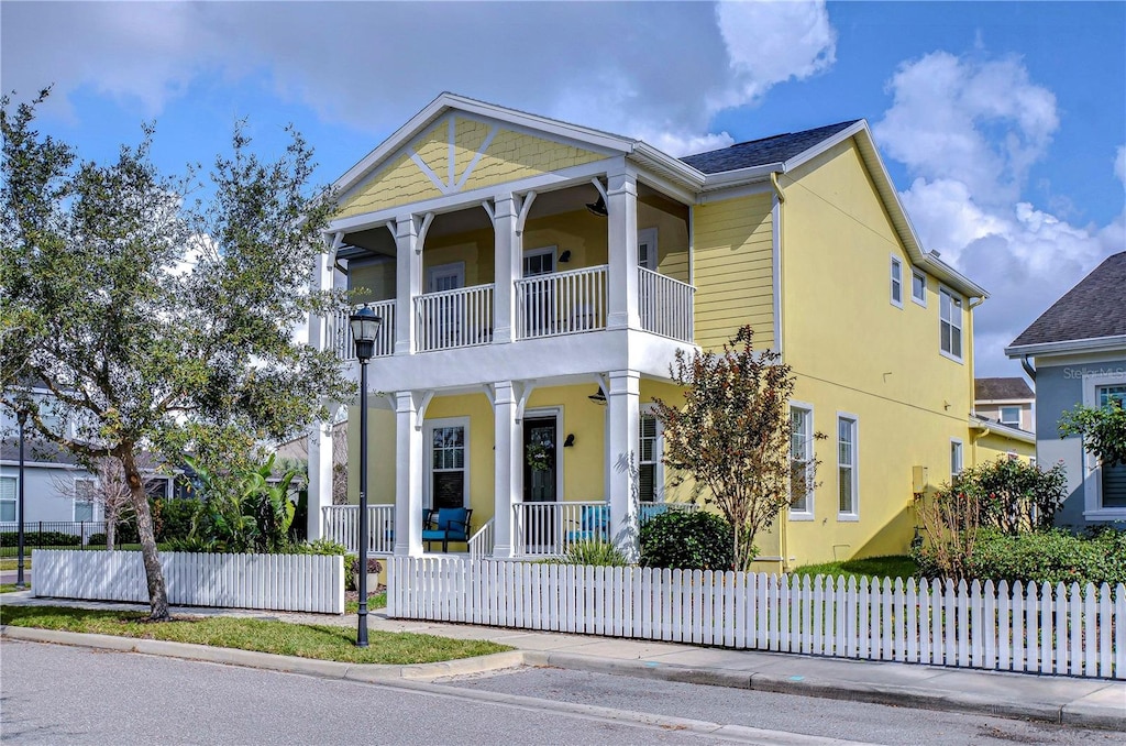 view of front of property with a balcony and covered porch