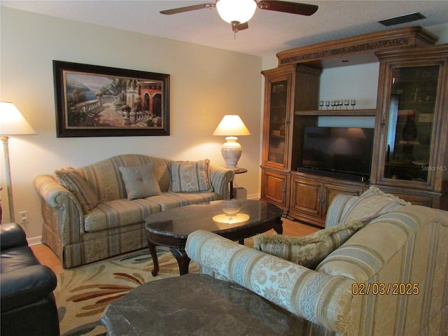 carpeted living room featuring ceiling fan