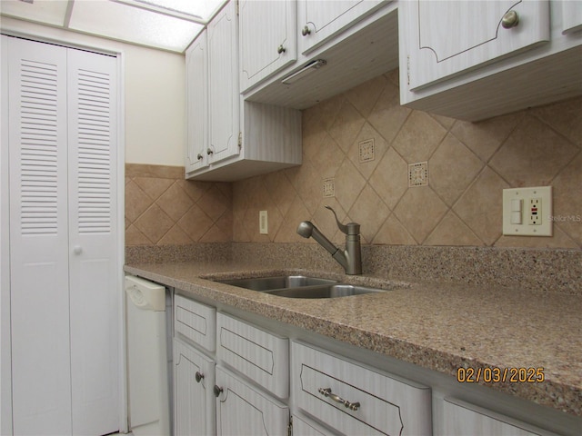 kitchen featuring white cabinetry, sink, decorative backsplash, and dishwasher