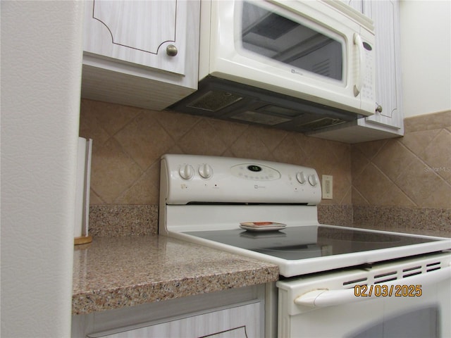 kitchen featuring white appliances and decorative backsplash