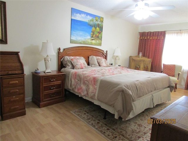 bedroom with ceiling fan and light hardwood / wood-style floors