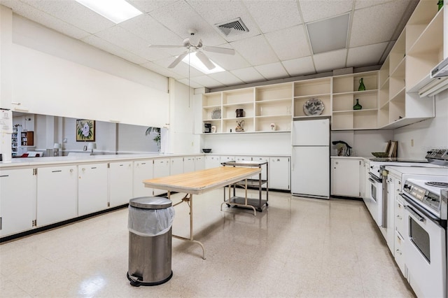 kitchen with white cabinetry, a paneled ceiling, ceiling fan, kitchen peninsula, and white appliances