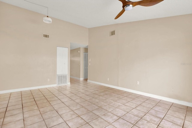 unfurnished room with vaulted ceiling, ceiling fan, and light tile patterned flooring