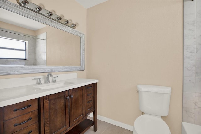 bathroom featuring vanity, tile patterned floors, and toilet