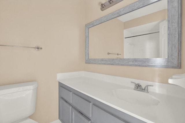 bathroom with vanity, a shower, and toilet