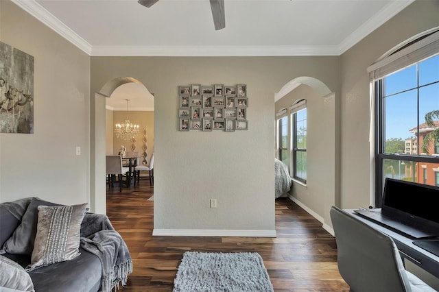 living room featuring crown molding, dark wood-type flooring, and ceiling fan with notable chandelier