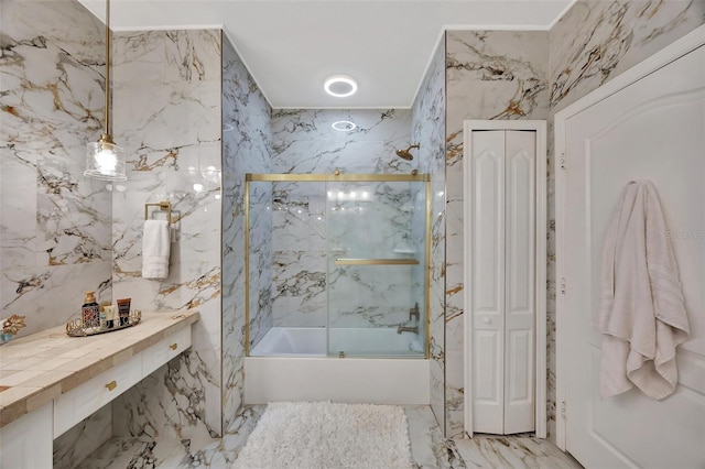 bathroom featuring tile walls and combined bath / shower with glass door