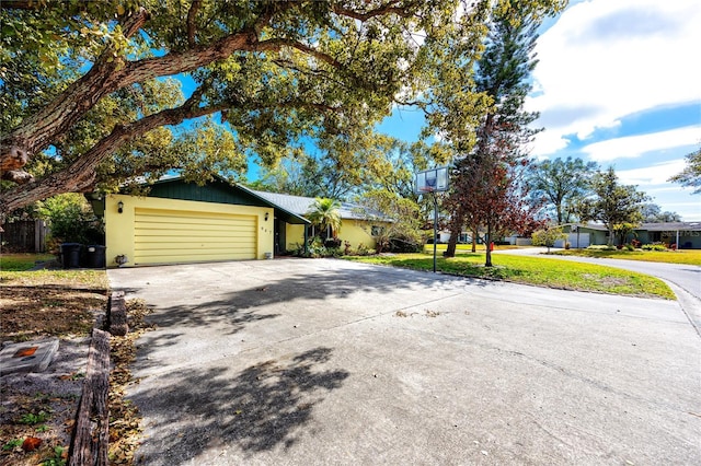 single story home with a garage and a front lawn