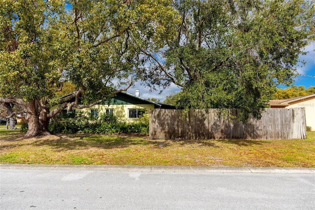 view of side of home with a yard