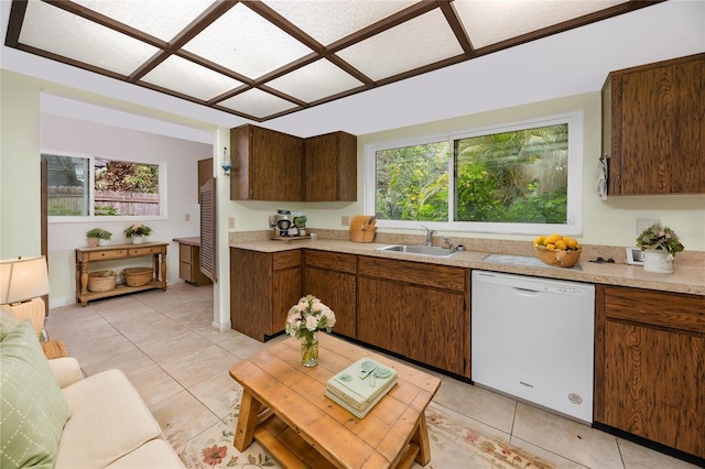 kitchen with sink, light tile patterned floors, and white dishwasher