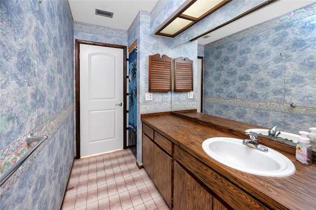 bathroom featuring tile patterned flooring and vanity